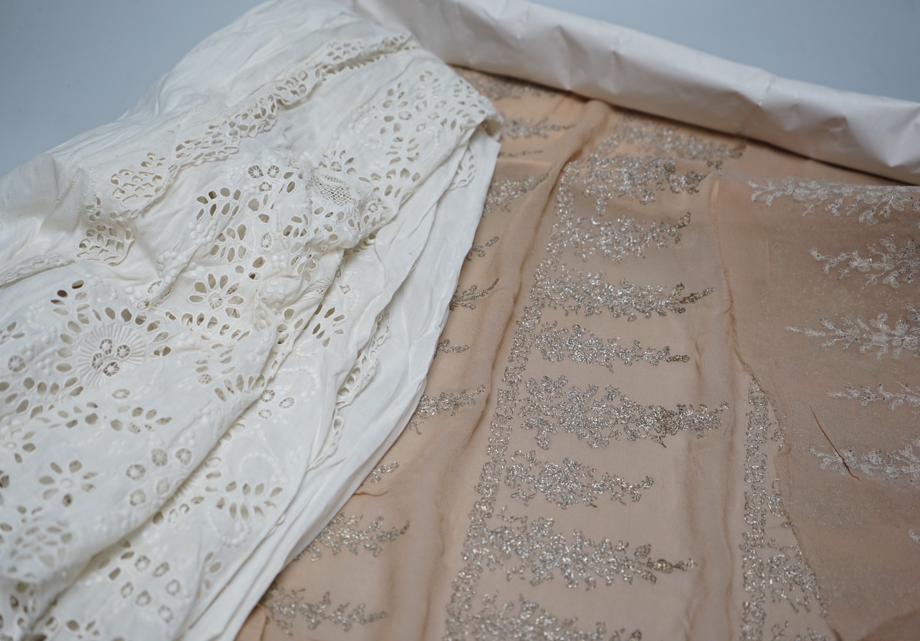 A long length of 1930’s silver lace trimming a similar panel, chiffon and silver embroidered fabric, an ornate 19th century cut worked christening gown etc